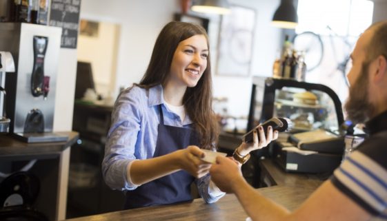 A Cafe Worker taking payment from a customer