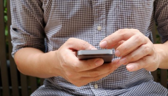 A man browsing on a mobile phone.