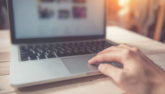 person-hand-using-laptop-on-table