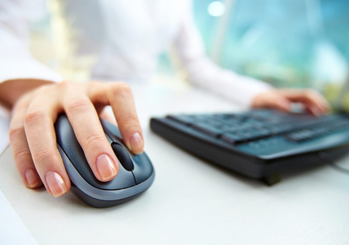 Image of female hands clicking computer mouse pay per click PPC concept