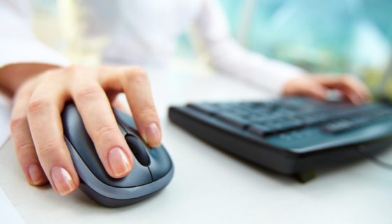 Image of female hands clicking computer mouse pay per click PPC concept