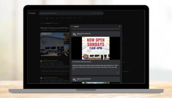 A Google Business Profile post from Westby Cheese and Gift Store is displayed on a laptop screen, announcing new Sunday hours with a graphic that reads “Now Open Sundays 11AM–4PM.”