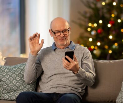 the-blu-group-advertising-&-marketing-accessibility-importance-during-holidays-man-on-couch-with-phone-holiday