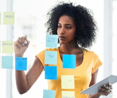 the-blu-group-advertising-&-marketing-how-to-set-realistic-marketing-goals-woman-working-notes-strategy