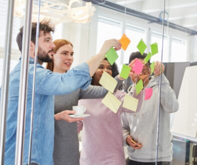 Team members collaborate on content planning and marketing strategy using sticky notes during a brainstorming session.
